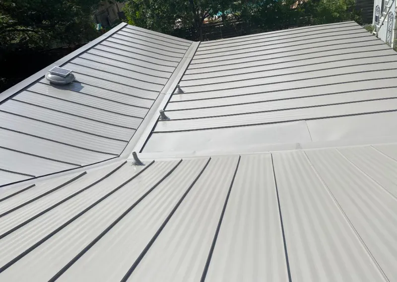 Solar attic fan installed on a metal roof for Roof Ventilation in Southeast